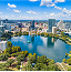 Aerial view of downtown Orlando, Florida, showcasing skyscrapers and urban landscape under a clear blue sky.