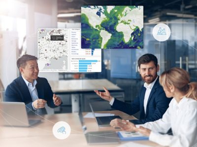  Business professionals working around a table with inset images of sales data  with numbers and graphs and geographic maps
