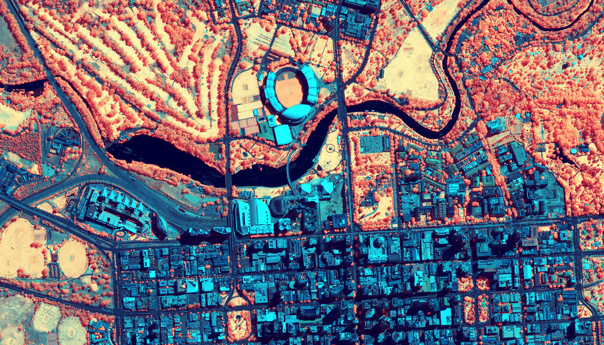 Imagery in an ArcGIS map of an urban area near a river