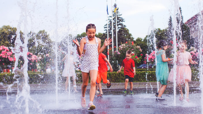 Kids playing in a water-based play space