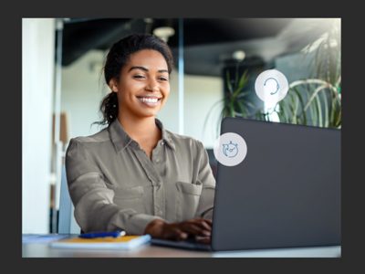 Woman working on laptop with a smile