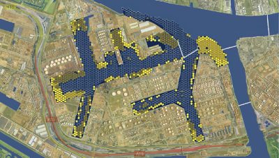 A digital map of a port shows proposed dredging areas highlighted in yellow hexagons