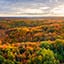 Aerial view over green and brown wooded hills
