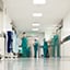 Hospital corridor with personnel in scrubs at work