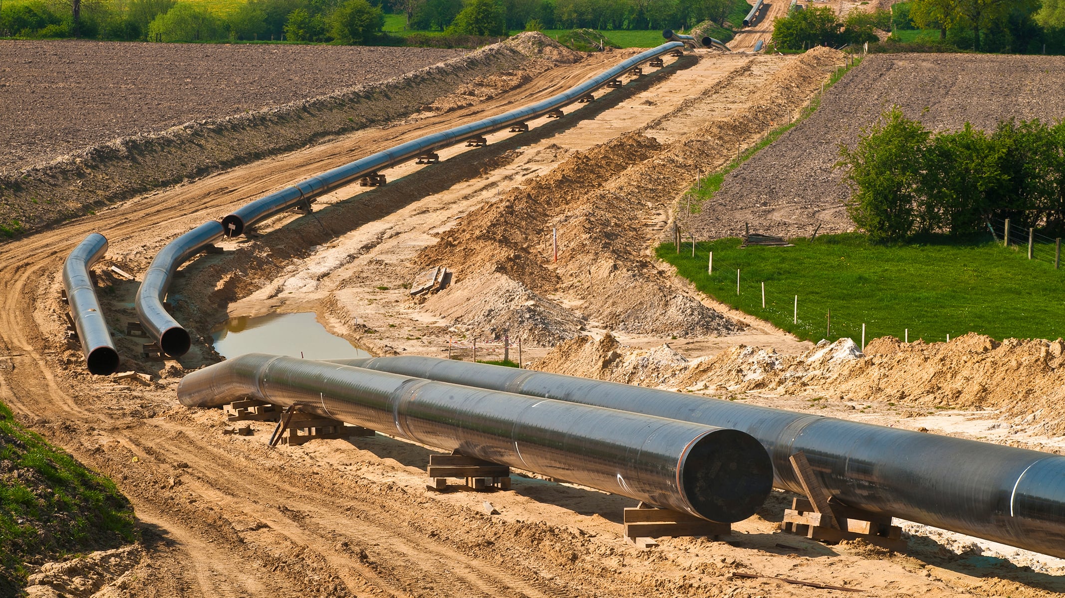 Huge energy network pipes getting assembled in a rural landscape