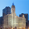 A panoramic view of Chicago's skyline featuring iconic buildings against a clear blue sky.