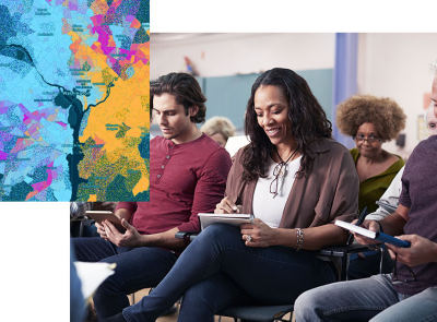 Multi-ethnic group sitting in a meeting taking notes